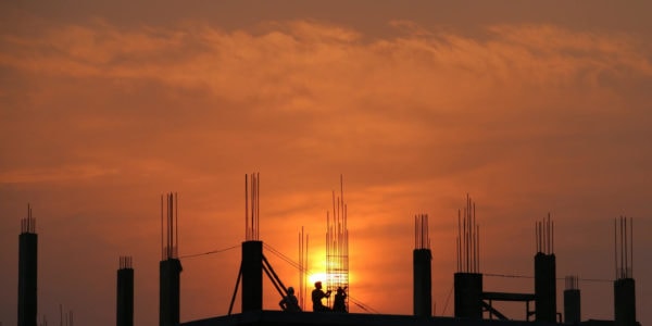 image of people working at the top of a house